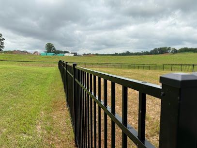 Straight and level aluminum fence line along a property boundary.