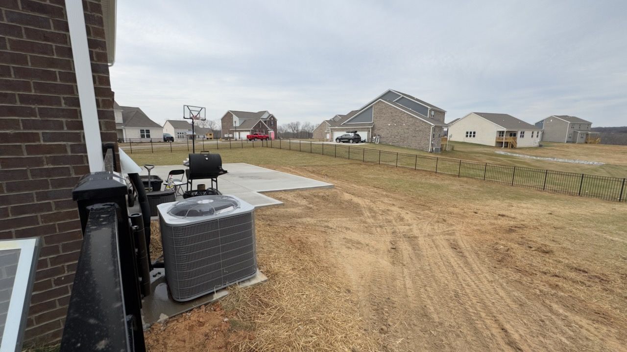 Expansive back patio concrete extension with a clean, brushed finish.