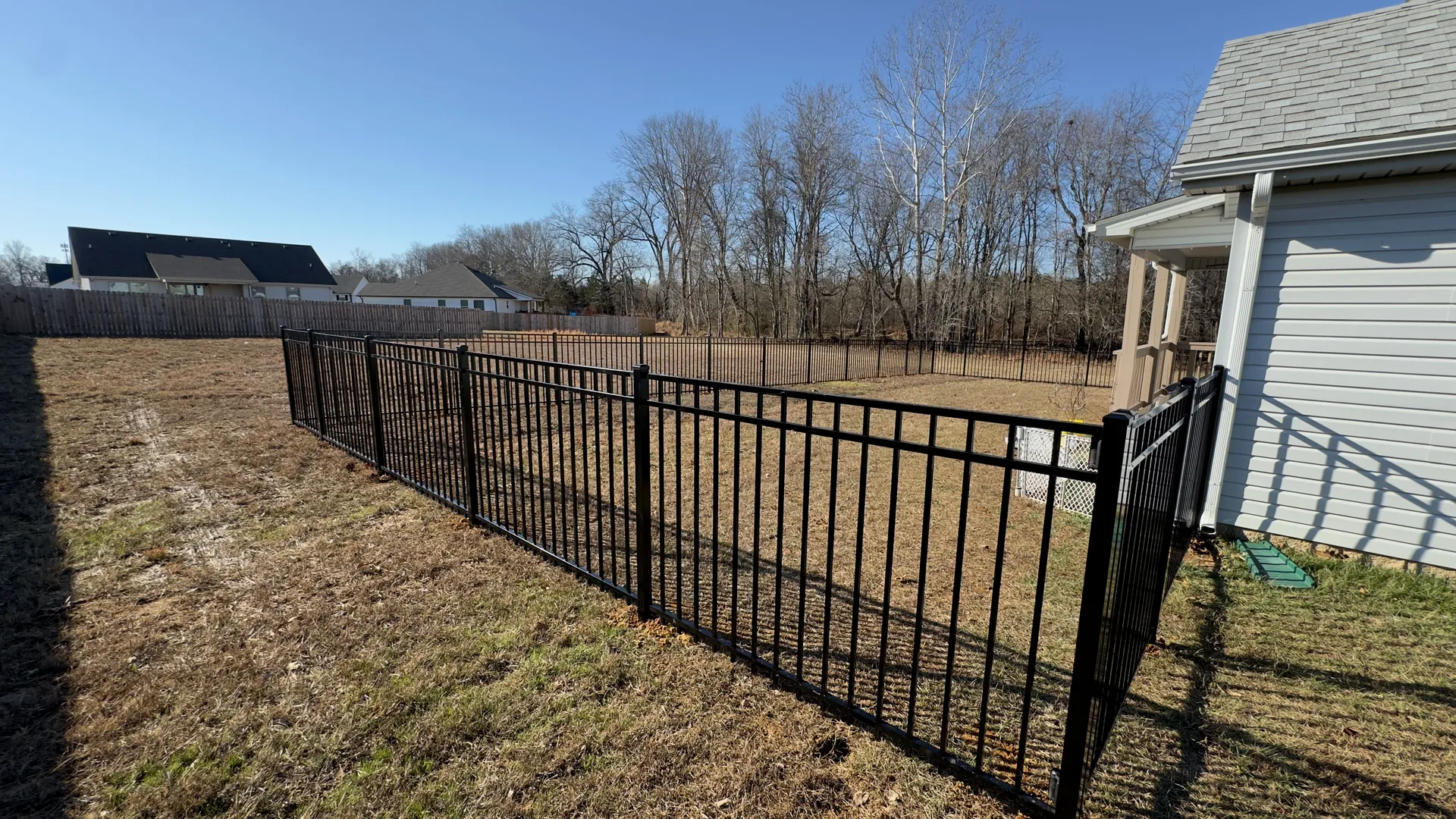 High-quality black aluminum fence defining a backyard space.