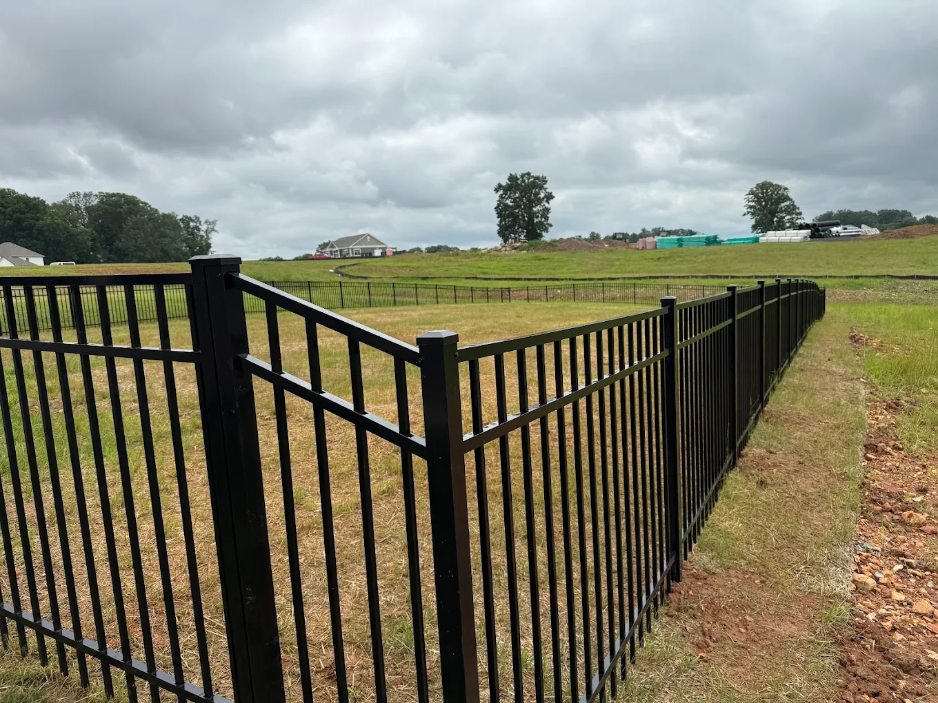 Stepped aluminum fence installation adapting to Clarksville's elevation changes.