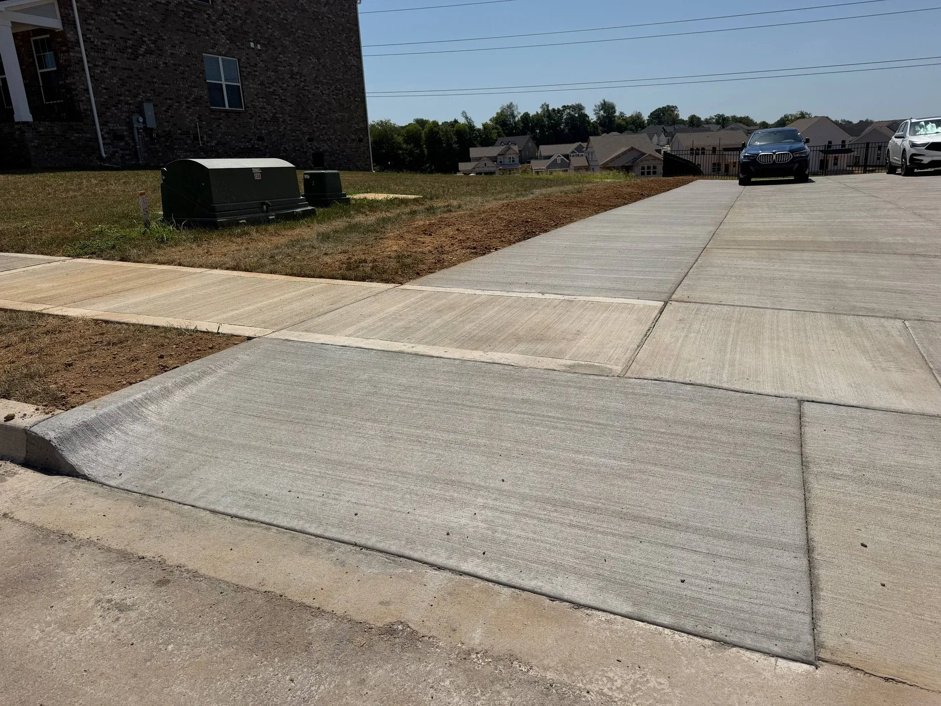 Concrete driveway apron joining the sidewalk and street